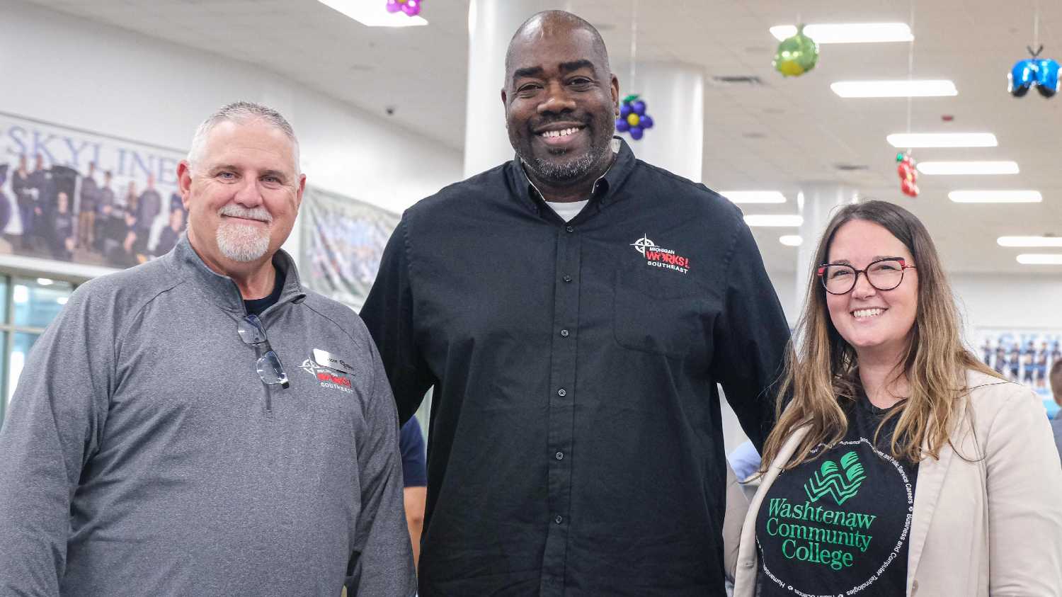 two men and a women smiling 